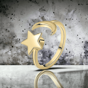 Moon and star ring gold adjustable on a shiny concrete surface