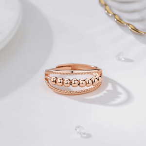 Rose-gold anxiety ring on a marble counter top