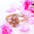 Ring for fidgeting with cherry blossom spinning top rose gold on white background