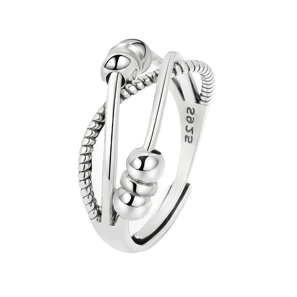 Silver triple band cross over fidget ring with sliding beads on white background