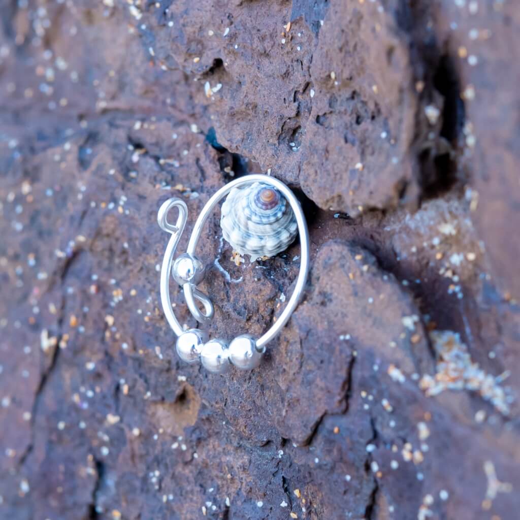 Sterling silver beaded adjustable ring on stone background