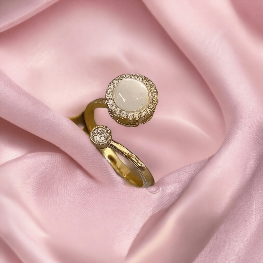 Adjustable silver fidget ring with an opal top on pink silk