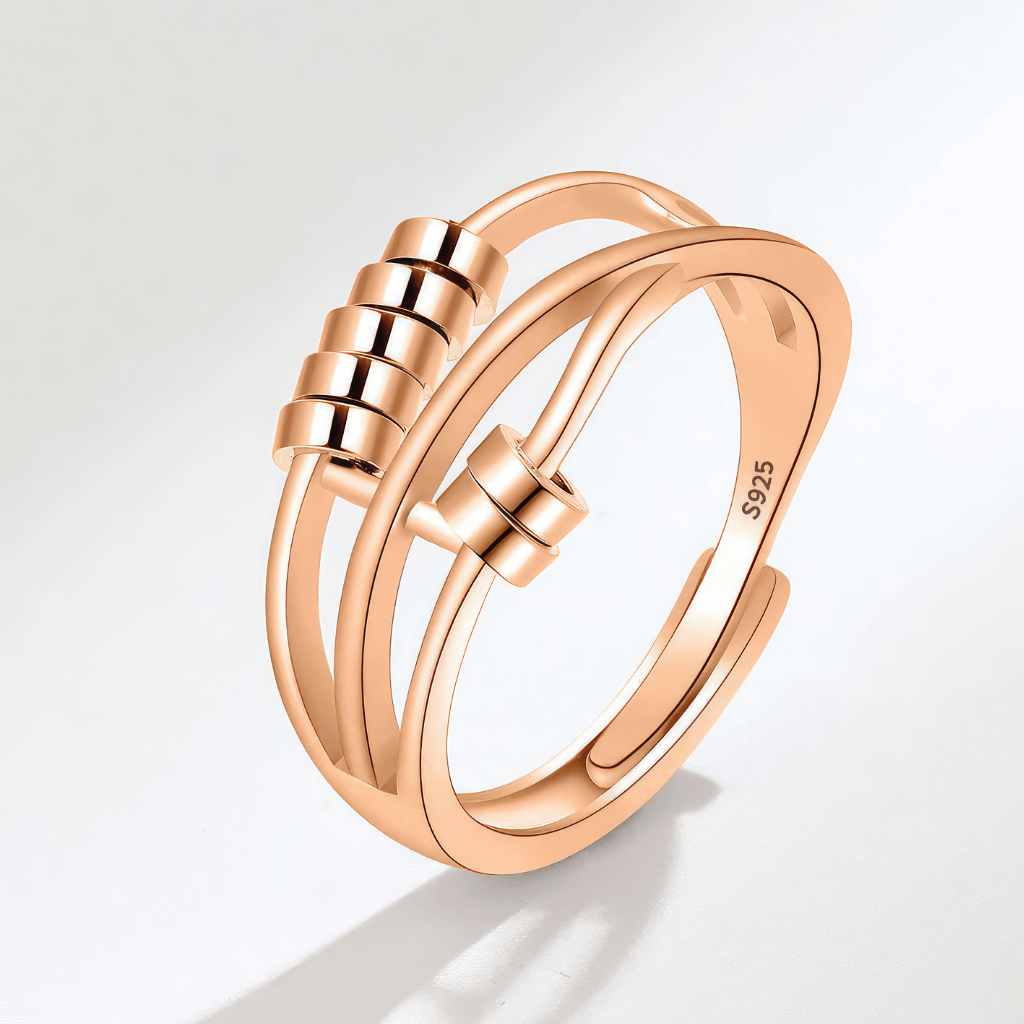 Beaded gold worry ring on grey background