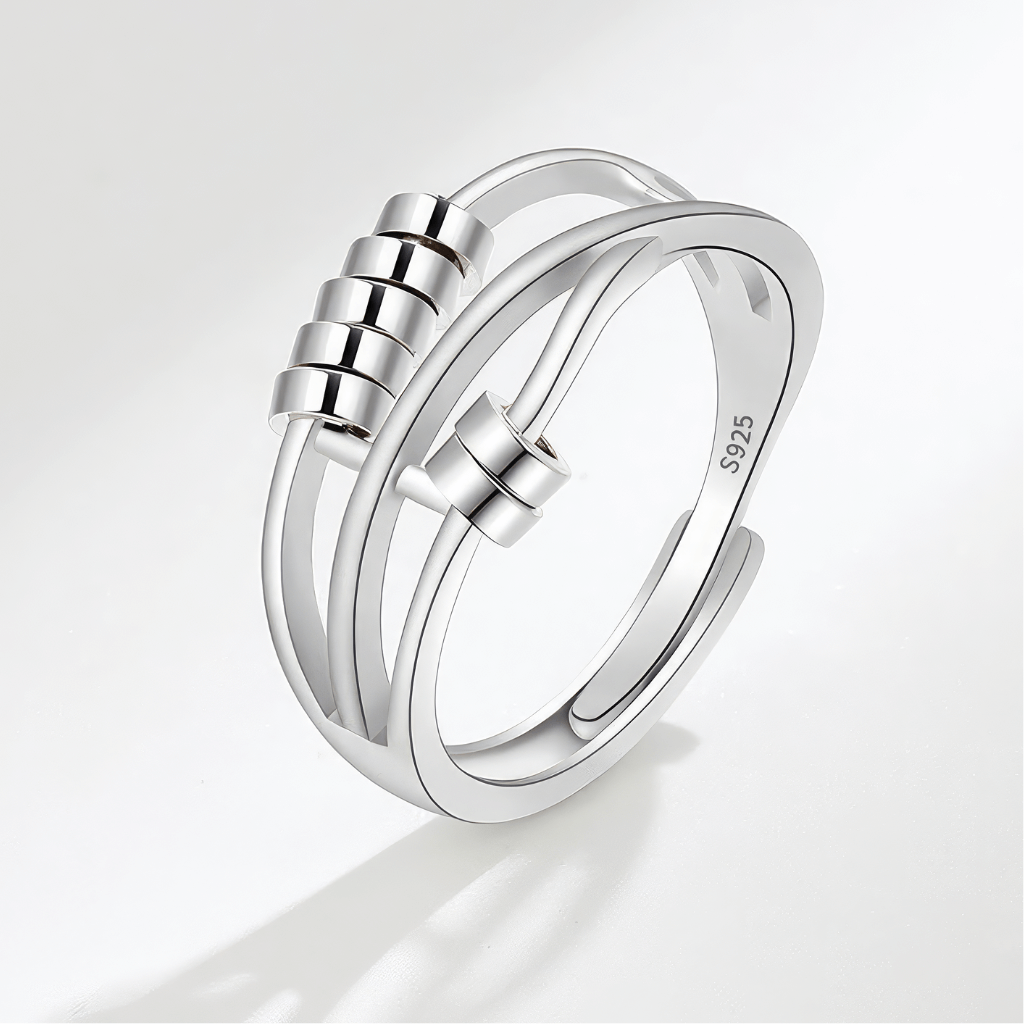 Beaded sterling silver calming ring on grey background