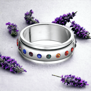 Cubic zirconia ring for fidgeting next to lavender flowers on grey background