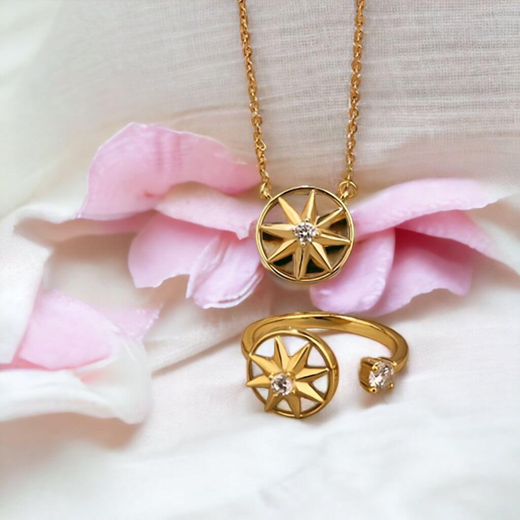 Fidget jewellery for adults sterling silver necklace and ring set on a white pillow next to pink petals