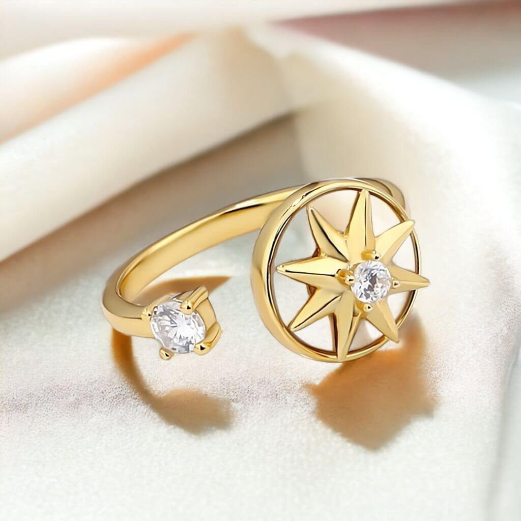 Fidget ring anxiety with a north star spinning top on a shiny beige surface and blurred beige background