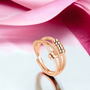 Fidget ring rose gold with pink fabric backdrop