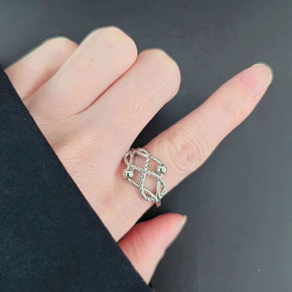 Fidget ring sterling silver with braided design and two beads on a white background