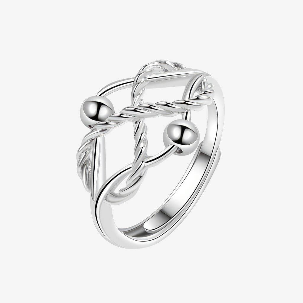 Fidget ring sterling silver with braided design and two beads on a white background