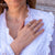 Fidgeting rings on a woman's hand on white shirt background