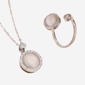 Jewelry set with a necklace and ring featuring round gemstones and rose gold accents on a white background.