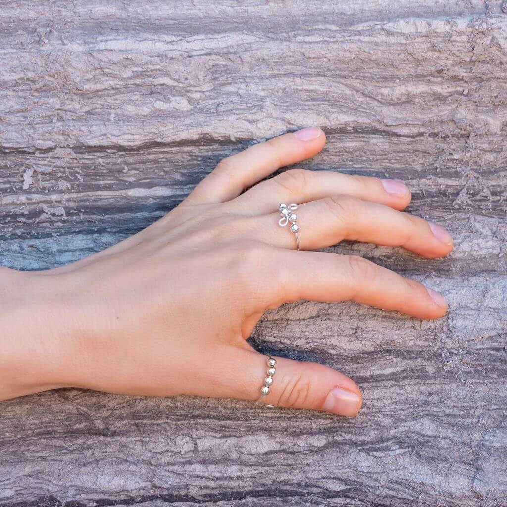 Jewellry for anxiety rings with beads on a woman's hand