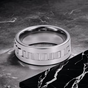 Men tungsten gear spinning ring on a black marble counter top