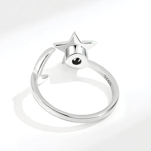 Back view of a moon and star ring ring adjustable sterling silver on white background