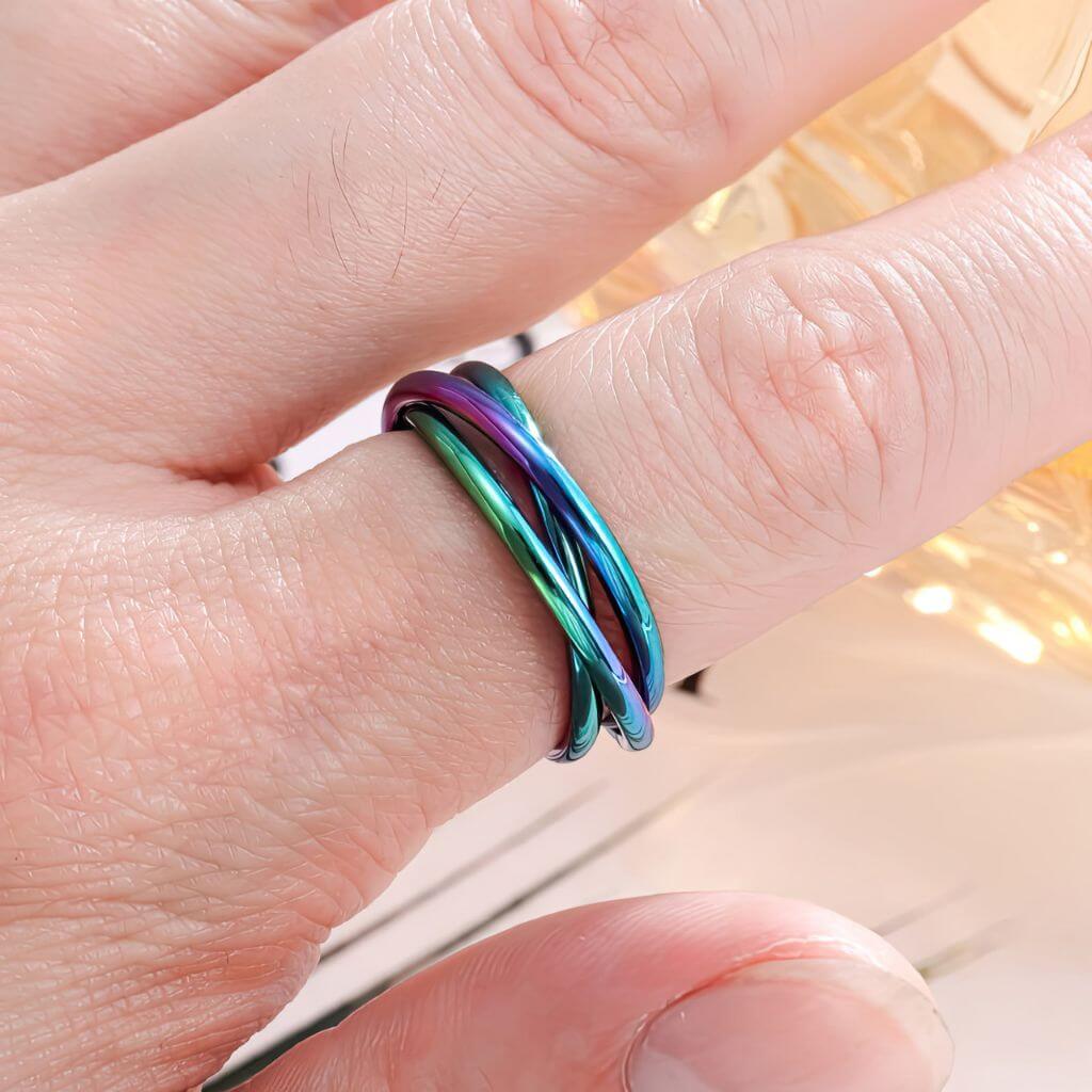 Multicolored ring on a finger with a blurred background