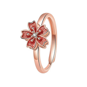 Ring for fidgeting with cherry blossom spinning top rose gold on white background