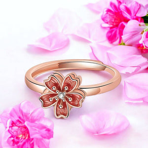 Sakura flower fidget ring rose gold with pink flowers background