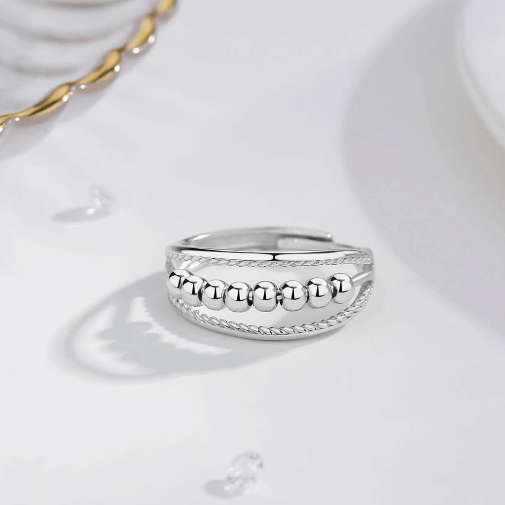 Silver anxiety ring on a marble counter top