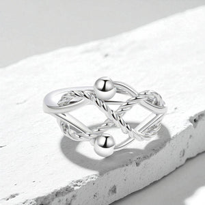 Silver fidget ring with geometric design on a white stone