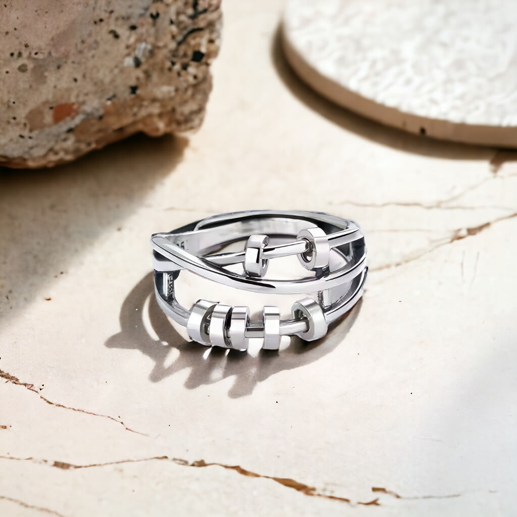 Silver fidgeting ring on a marble counter top