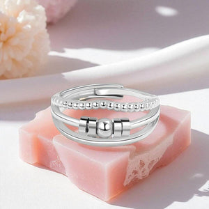 Silver ring on a pink soap block with a soft background