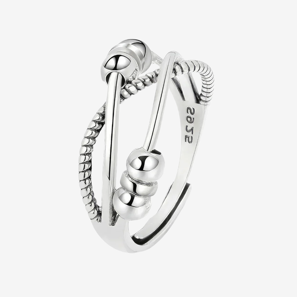 Silver triple band cross over fidget ring with sliding beads on white background