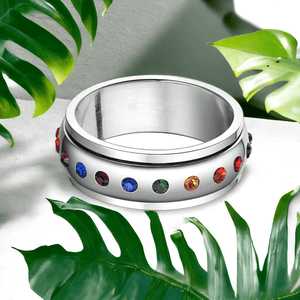 Stainless steel cubic zirconia ring surrounded by green monstera leaves