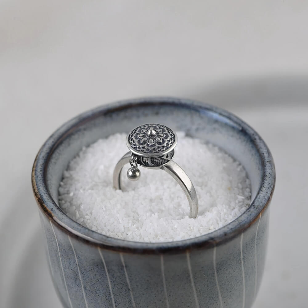 Sterling silver buddhist tibetan spinning ring in a bowl with salt