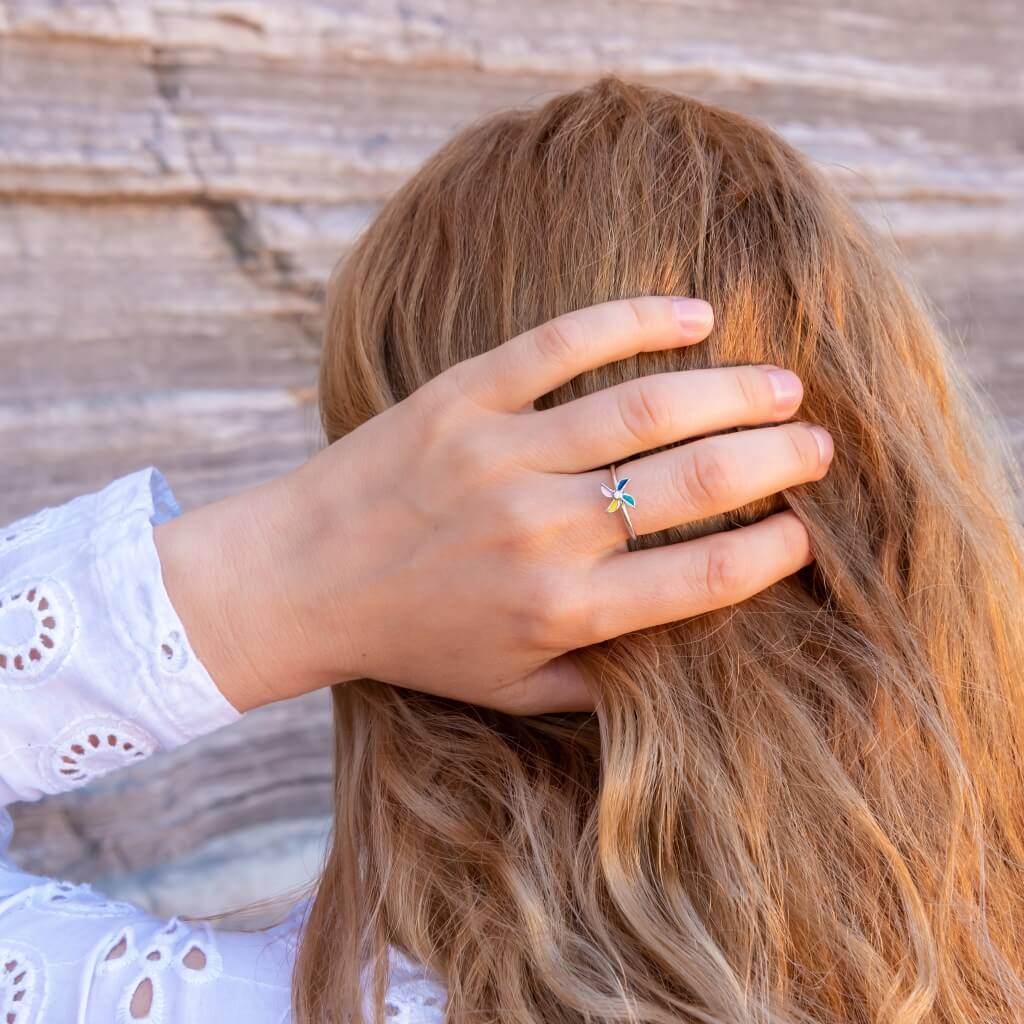 Woman holding her hair wearing a windmill anxiety fidget ring