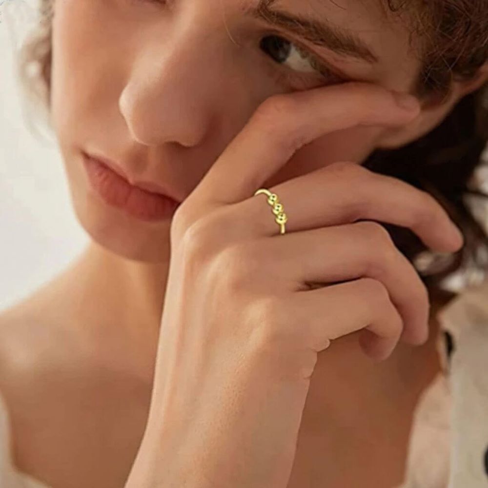 Woman wearing a gold stainless steel beaded ring