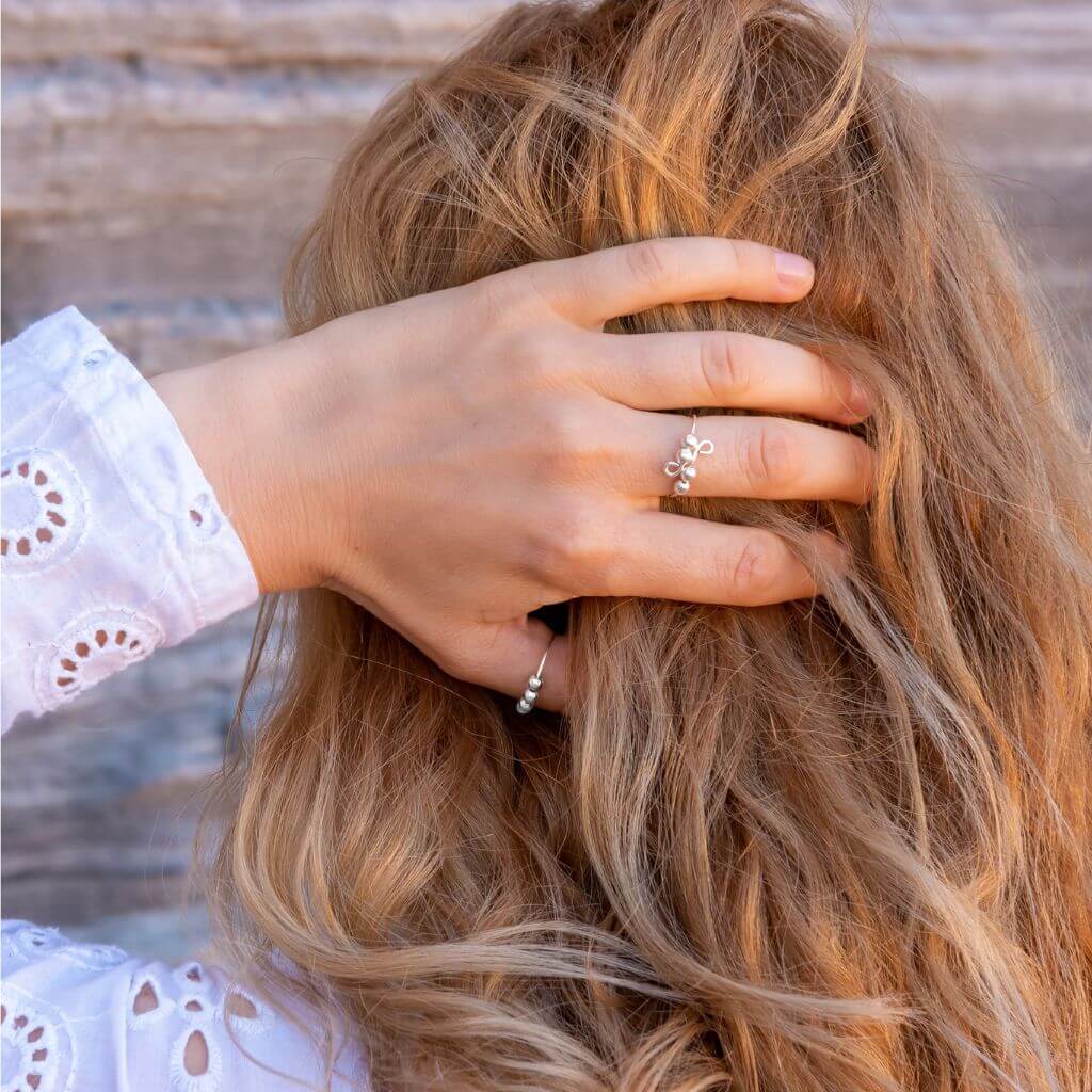 Woman holding hair while wearing jewellery for anxiety 