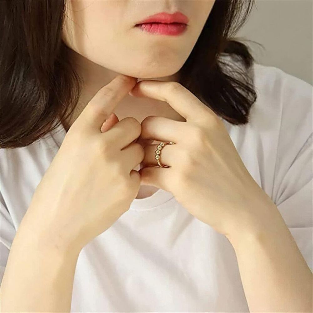 Woman wearing a sterling silver adjustable ring with 4 beads