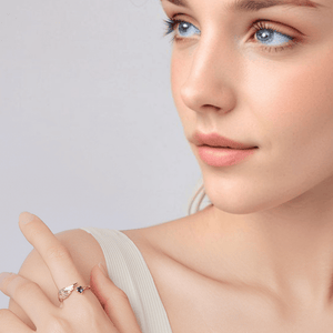 Angel wing heart ring worn by model featuring wing design and heart shaped gemstone