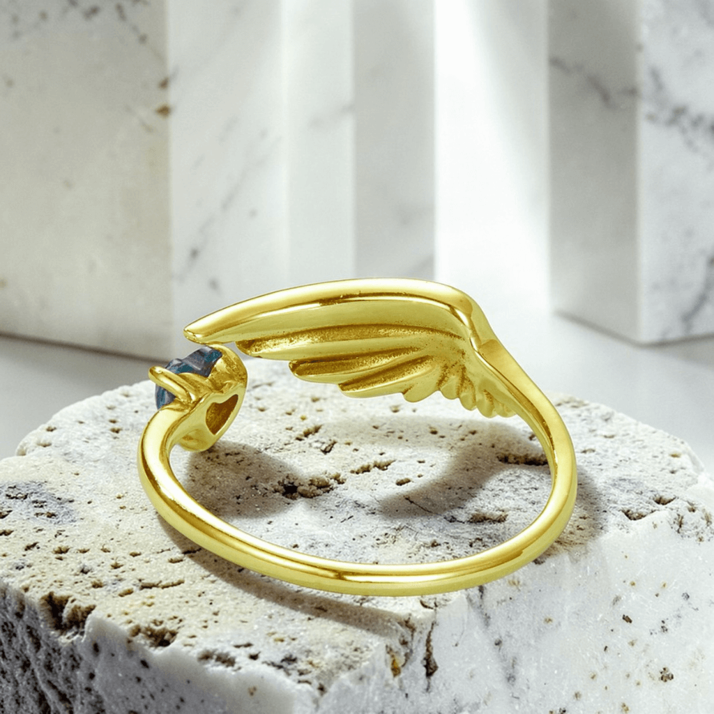 Gold angel wing anxiety ring back view showing adjustable open band and wing design