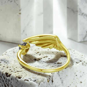 Gold angel wing anxiety ring back view showing adjustable open band and wing design