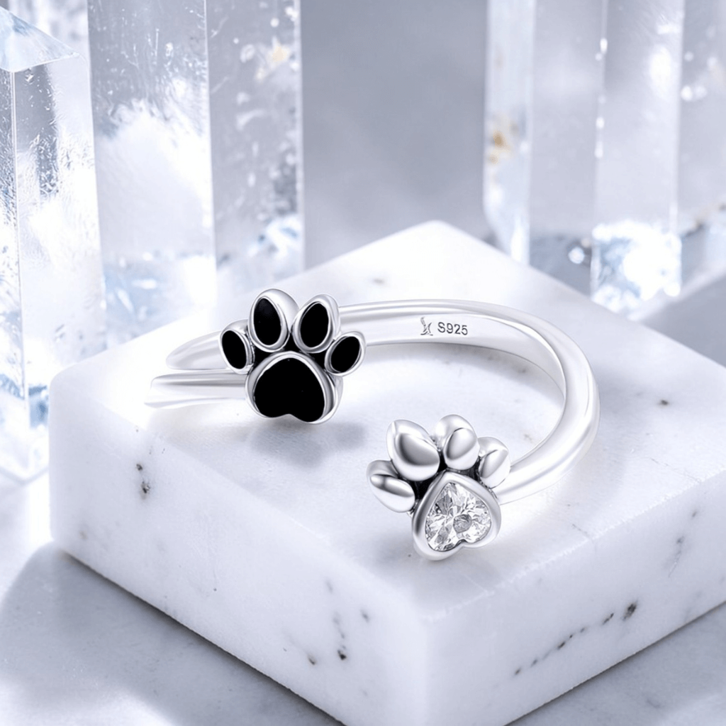 sterling silver paw print anxiety ring with black enamel paw and heart cubic zirconia dog ring jewelry on marble display