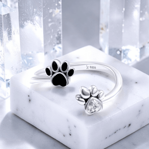 sterling silver paw print anxiety ring with black enamel paw and heart cubic zirconia dog ring jewelry on marble display