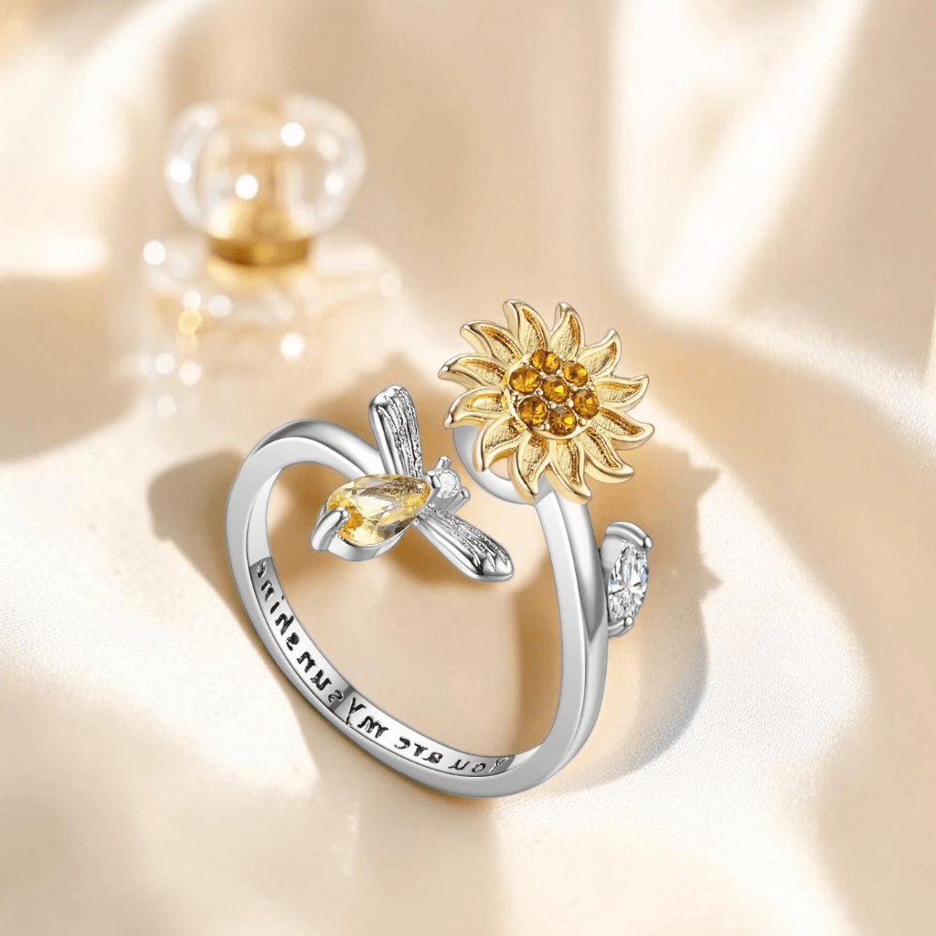 Two-tone rhodium plated 925 silver and gold sunflower bee spinner fidget ring with you are my sunshine engraving on white background