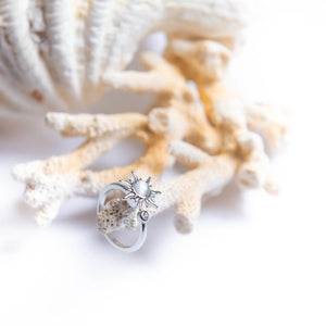 Findget ring for anxiety with sun spinning top on a white coral
