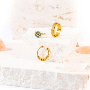 Grounding pack bundle of 3 fidget rings gold on a white stone