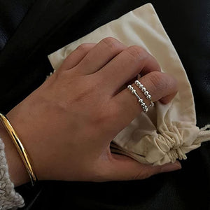 Rings with beads on a woman's index finger