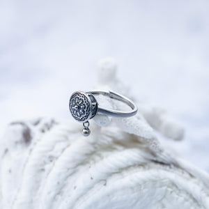 Spinning ring made of sterling silver after the Buddhist Tibetan prayer wheel  on a coral
