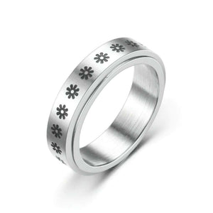 Stainless steel spinning flower ring on white background