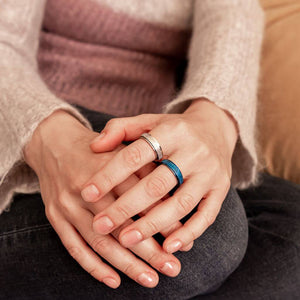 Woman wearing blue and rose gold sparkly worry rings
